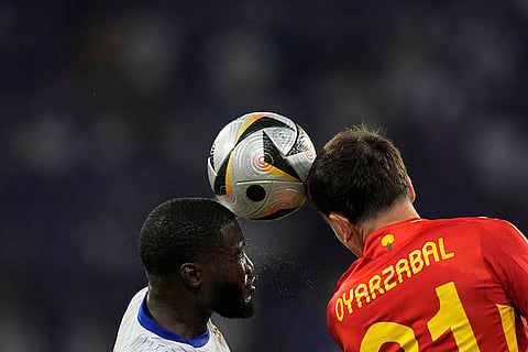 Dayot Upamecano jumps for the ball with Mikel Oyarzabal 